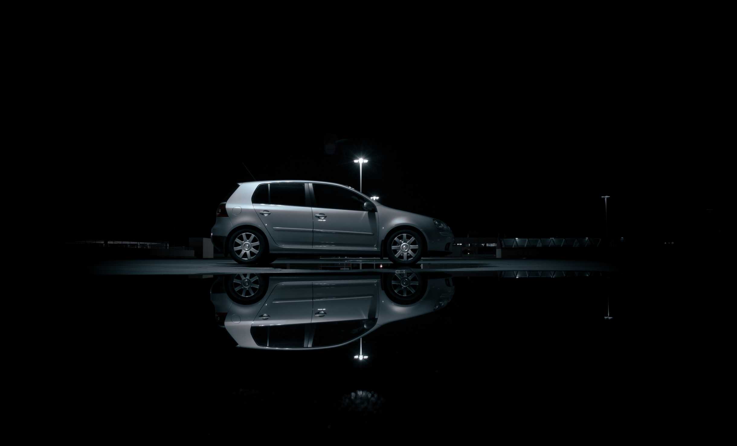 Side on view with a VW Golf reflection in a puddle