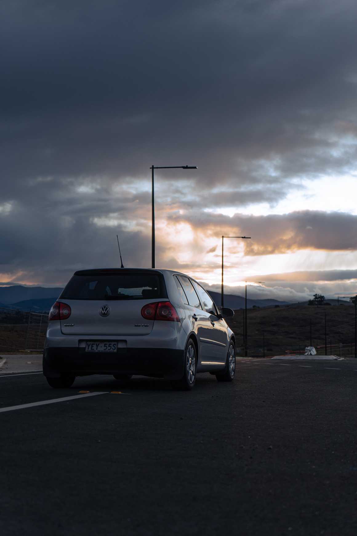 Rear view of a VW Golf with a sunset in the background